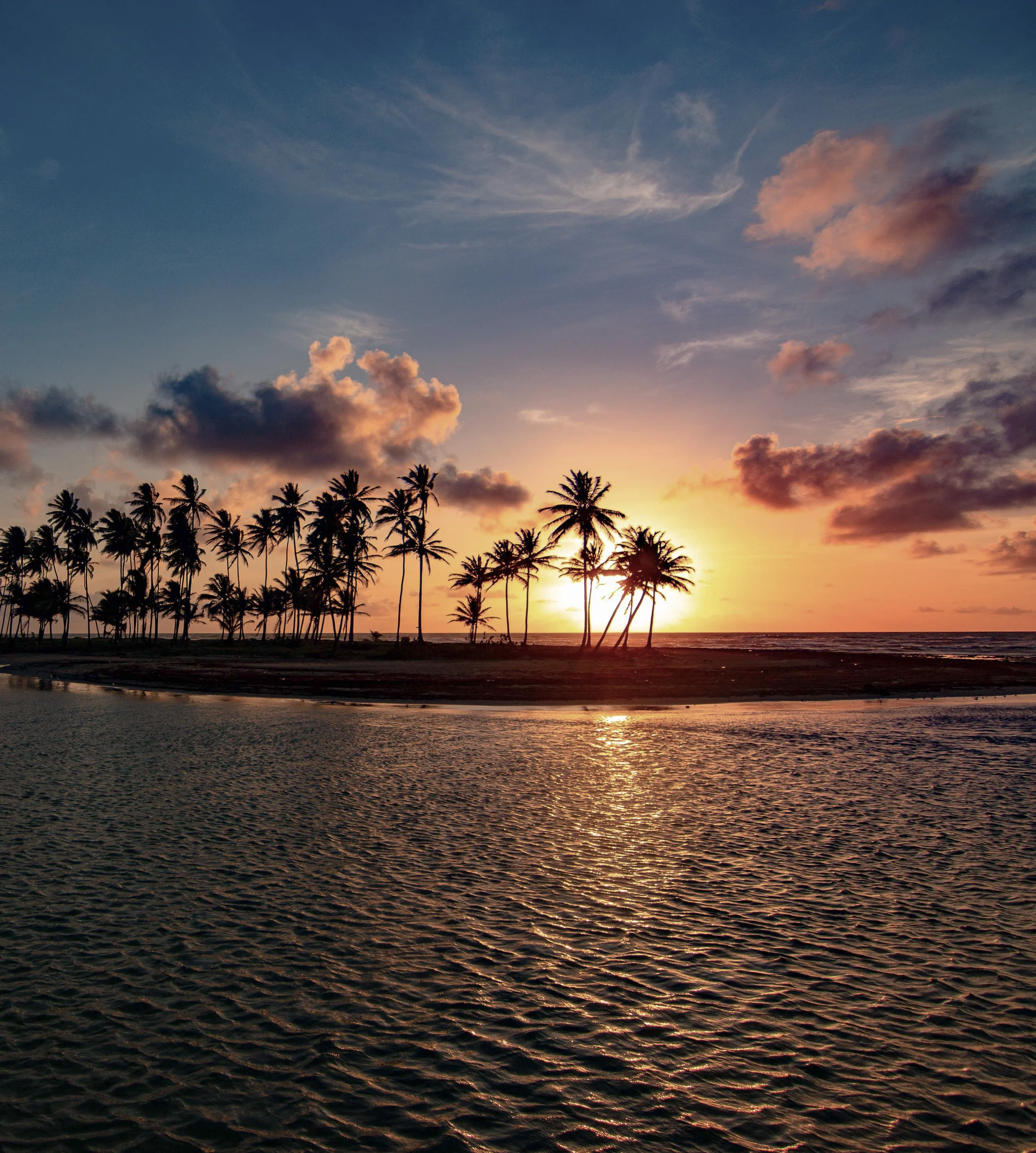 Sun setting over ocean